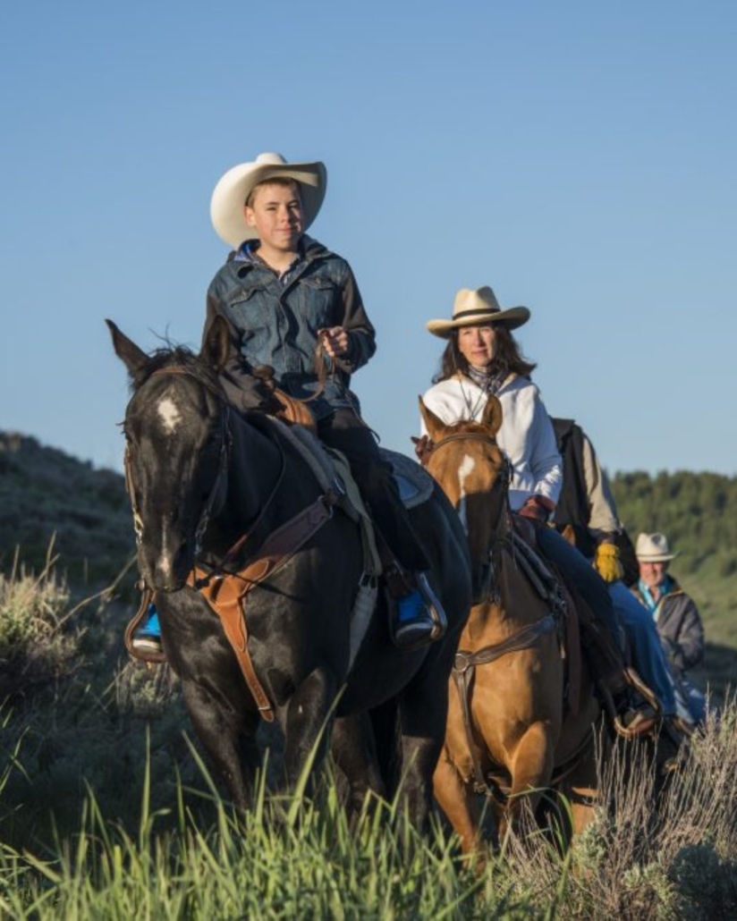 Two riders on horses at Spring Creek Ranch